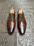 Brown leather classic shoes with green accent